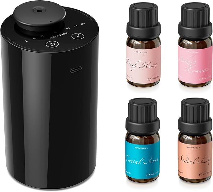 Black diffuser with four essential oil bottles on a white background